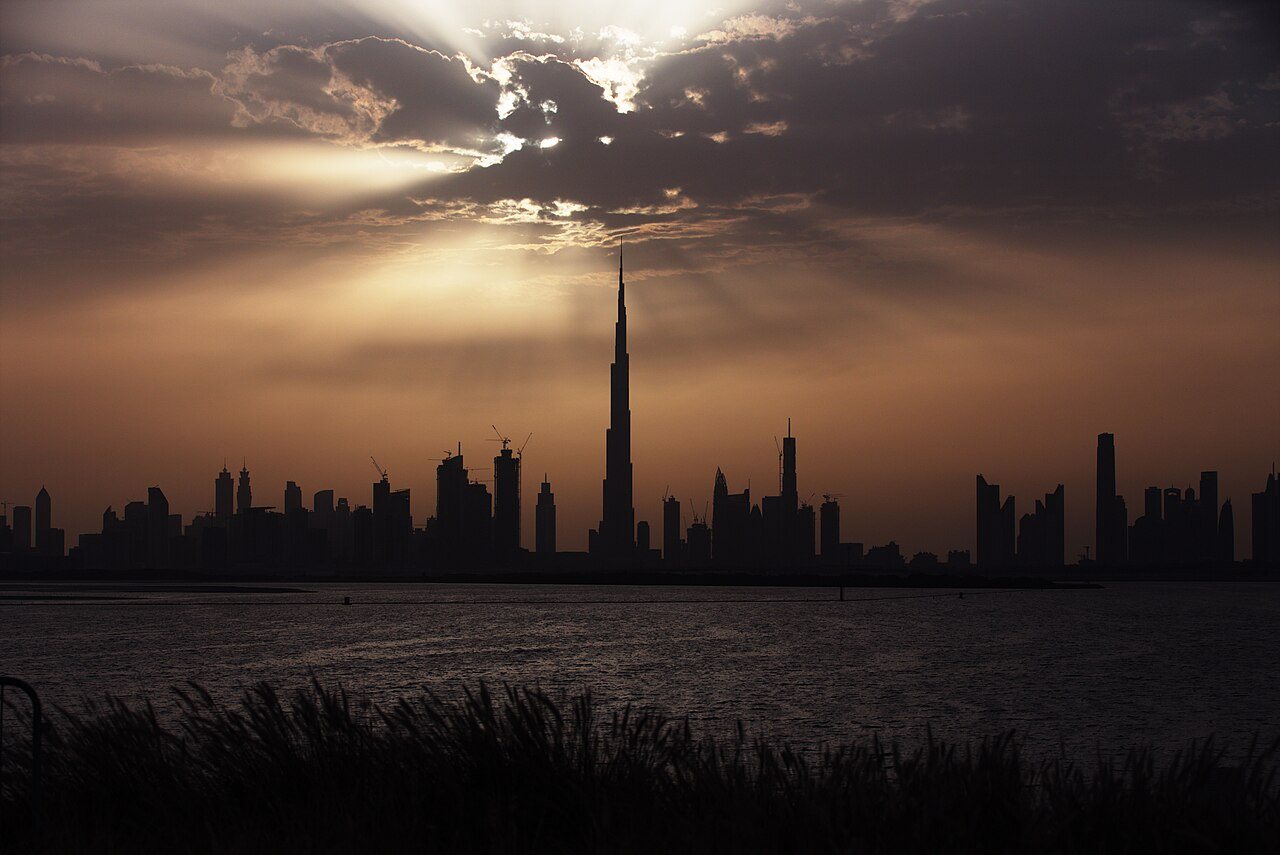 Burj Khalifa rising above Dubai's skyline at sunset