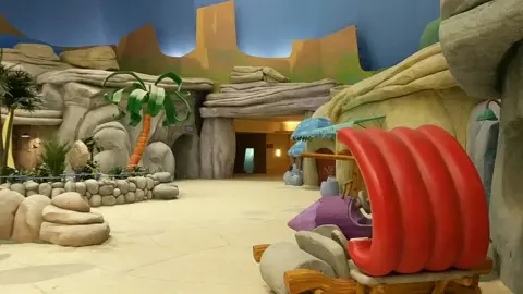 Bedrock-themed attraction area inside Warner Bros. World Abu Dhabi