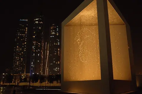 The Constellation artwork and monumental enclosure after dark.
