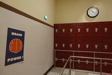 A themed queue area with lockers and a Brain Power sign