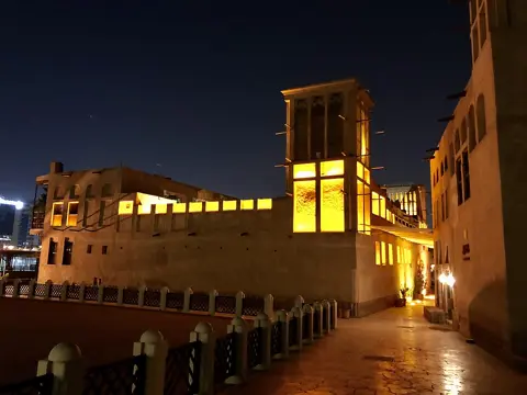Wind-tower architecture illuminated after dark