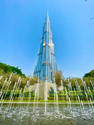Burj Khalifa rises above the lakefront in clear daylight