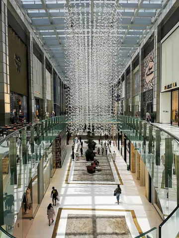 An upper-level view along the mall’s glazed shopping galleries
