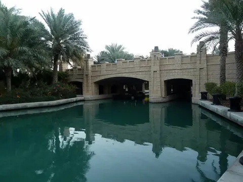 A bridge spans the waterway beside the souk