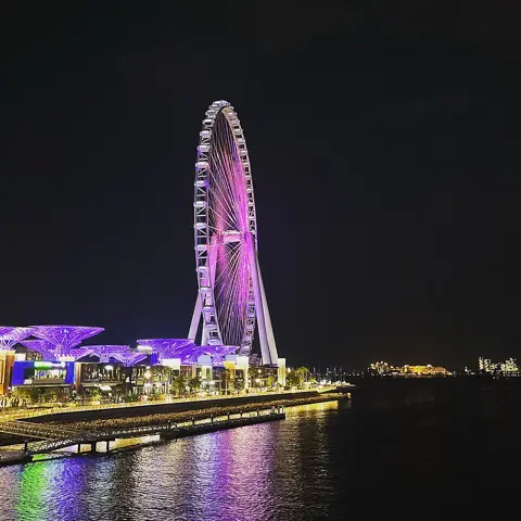 Ain Dubai and the Bluewaters waterfront illuminated after dark