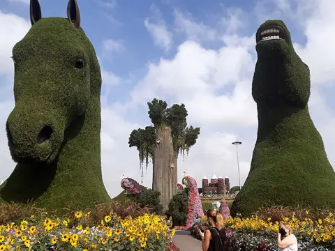 Tall animal-shaped topiary sculptures in the garden