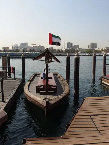 A wooden abra waits beside its boarding pontoon on Dubai Creek, photographed in 2014