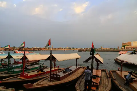 Bur Dubai Abra Station and moored boats in warm evening light, photographed in 2018