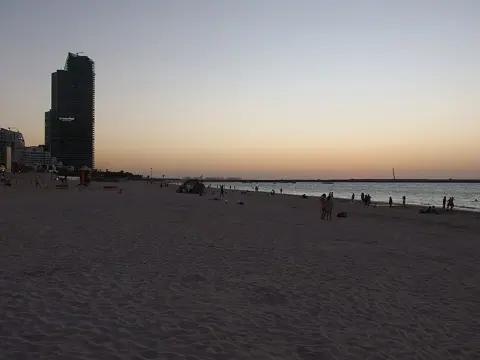The beach at sunset with Ain Dubai on the horizon