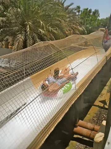 A rider travels down an open flume on an inflatable at Wild Wadi, photographed in 2012
