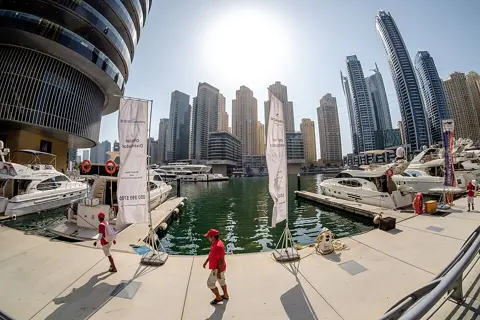 A waterfront promenade beneath the Marina’s residential towers