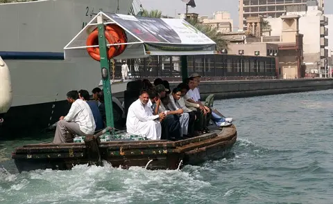 Passengers travel across the creek in an open-sided abra, photographed in 2007