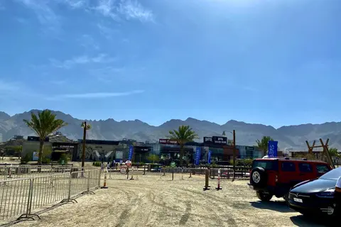The open activity grounds of Hatta Wadi Hub backed by rocky hills