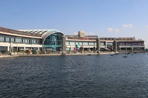 The waterfront façade of Festival City Mall in daylight