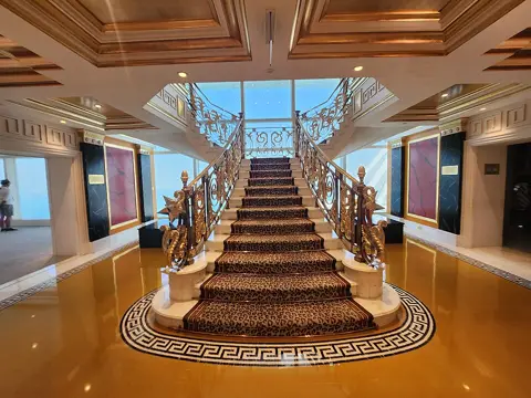 The ornate staircase and richly coloured interior décor