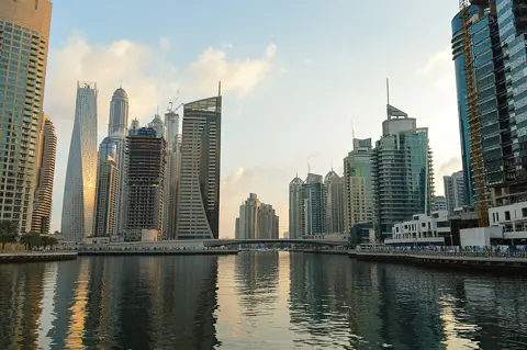 Marina towers and boats reflected in the water