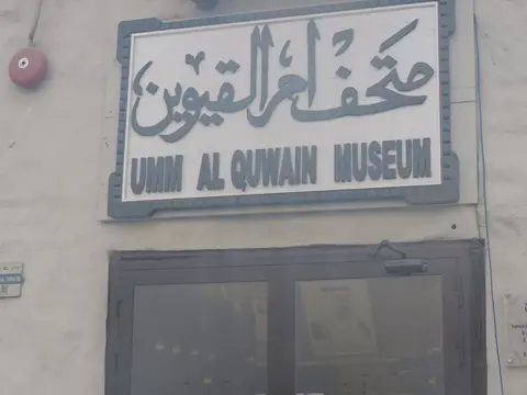 دو زبانوں کے بورڈ کے نیچے میوزیم کا داخلی دروازہ۔